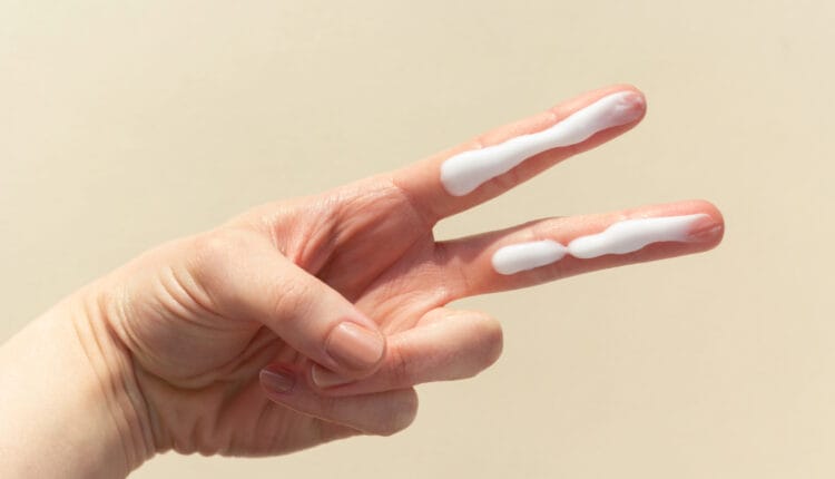two fingers with sunscreen