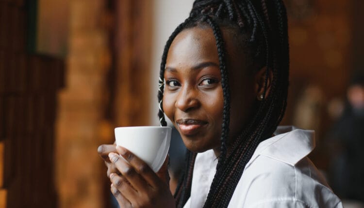 woman drinking coffee and smiling