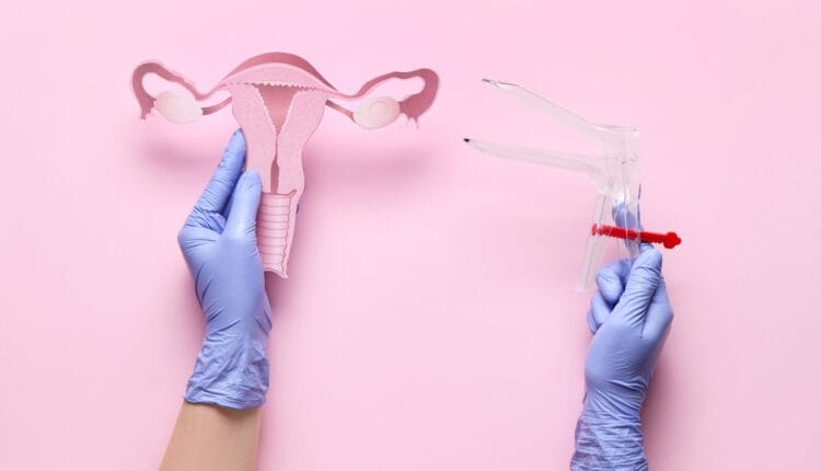 Pap smear speculum next to uterus model